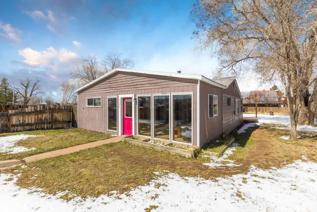 a view of a house with a yard and tree