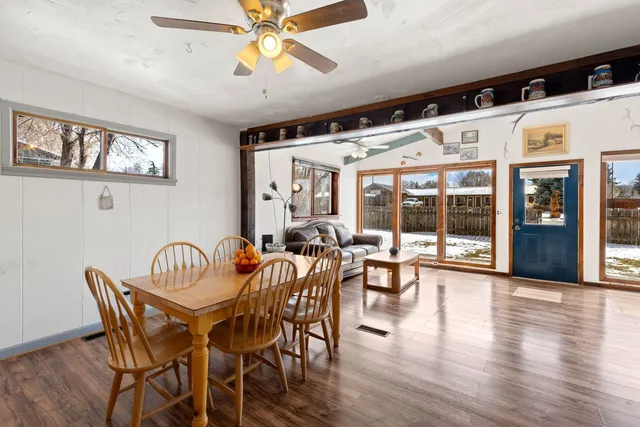 a view of a dining room with furniture wooden floor and chandelier