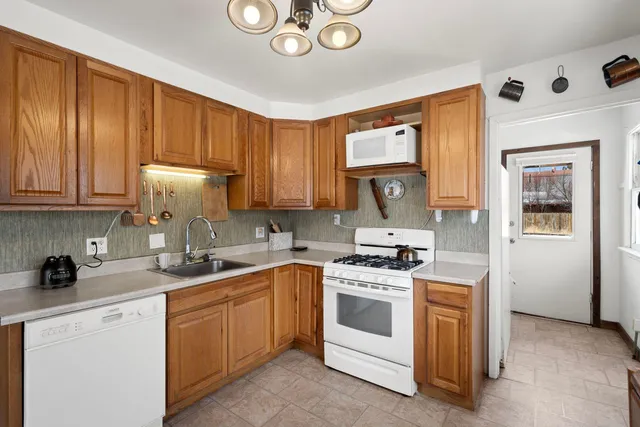 a kitchen with a stove cabinets and a sink