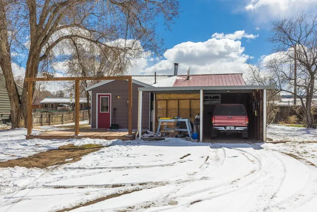a view of a house with a yard covered in snow