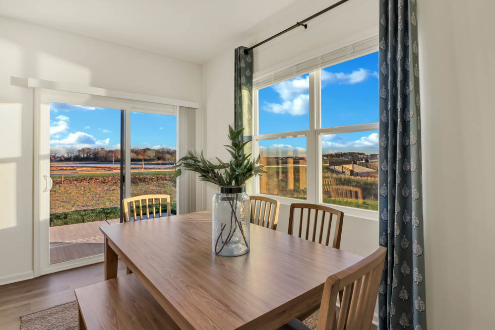 2477 Semillon Street Oswego, IL 60543 - Photo 9 of 20 a view of a dining room with furniture window and wooden floor