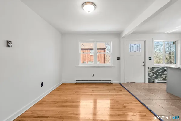 a view of a room with wooden floor and entryway