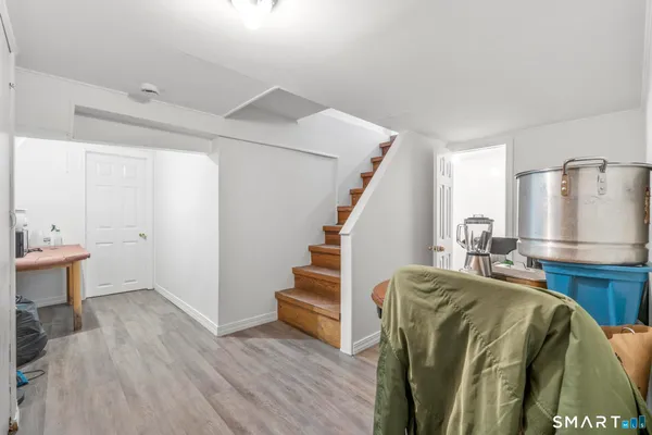 a view of hallway with wooden floor and stairs