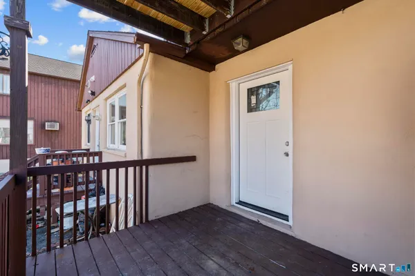 a view of a balcony with wooden floor