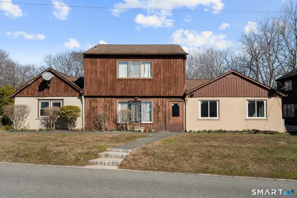 a front view of a house with a yard