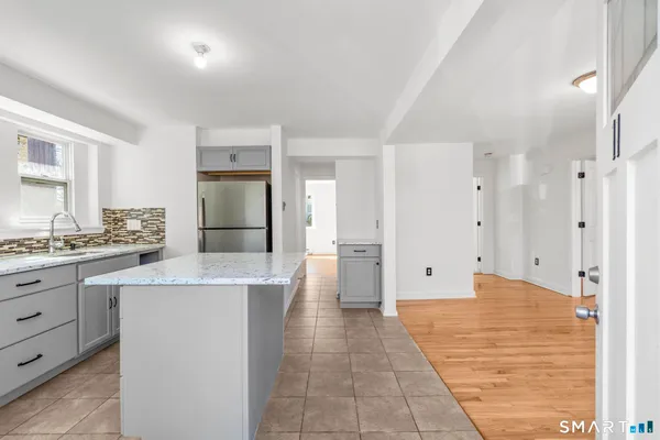 a large bathroom with a granite countertop sink a large mirror and shower