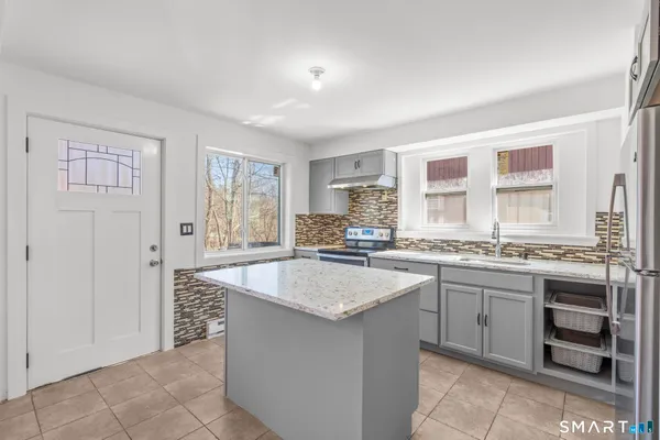 a kitchen with granite countertop a sink and cabinets