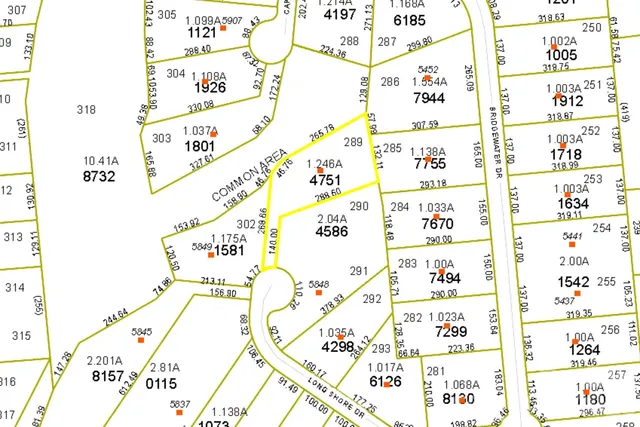 a yellow house with trees in front of it