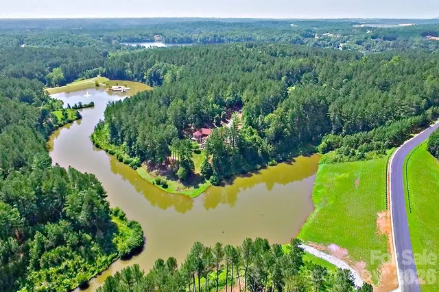 a view of a small house with a garden and plants