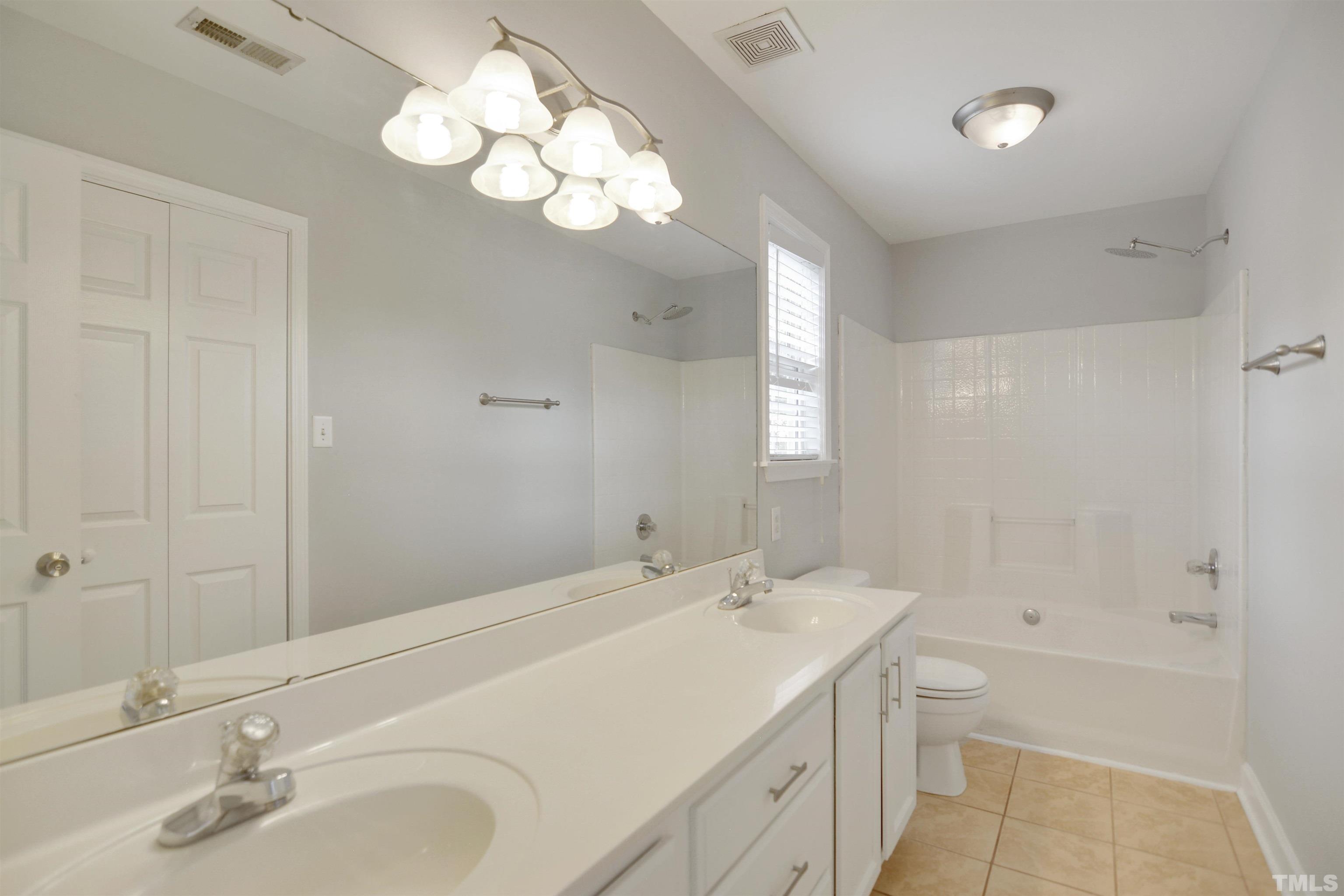 9221 Pennythorne Court Raleigh, NC 27615 - Photo 11 of 23 a bathroom with a tub sink and mirror