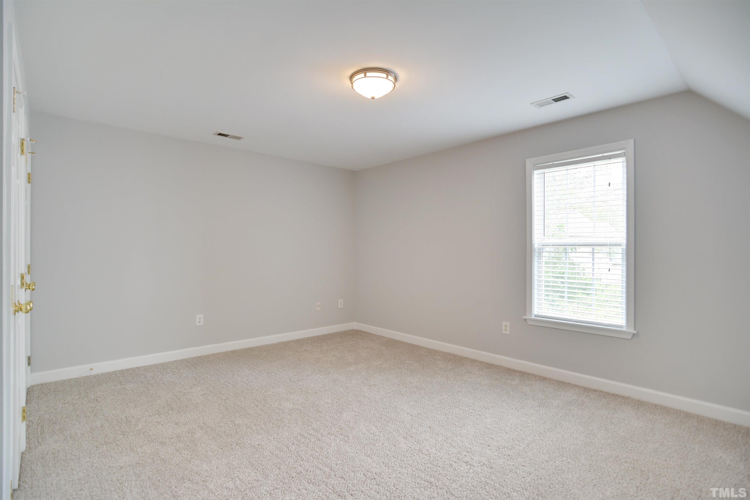 9221 Pennythorne Court Raleigh, NC 27615 - Photo 12 of 23 an empty room with a window
