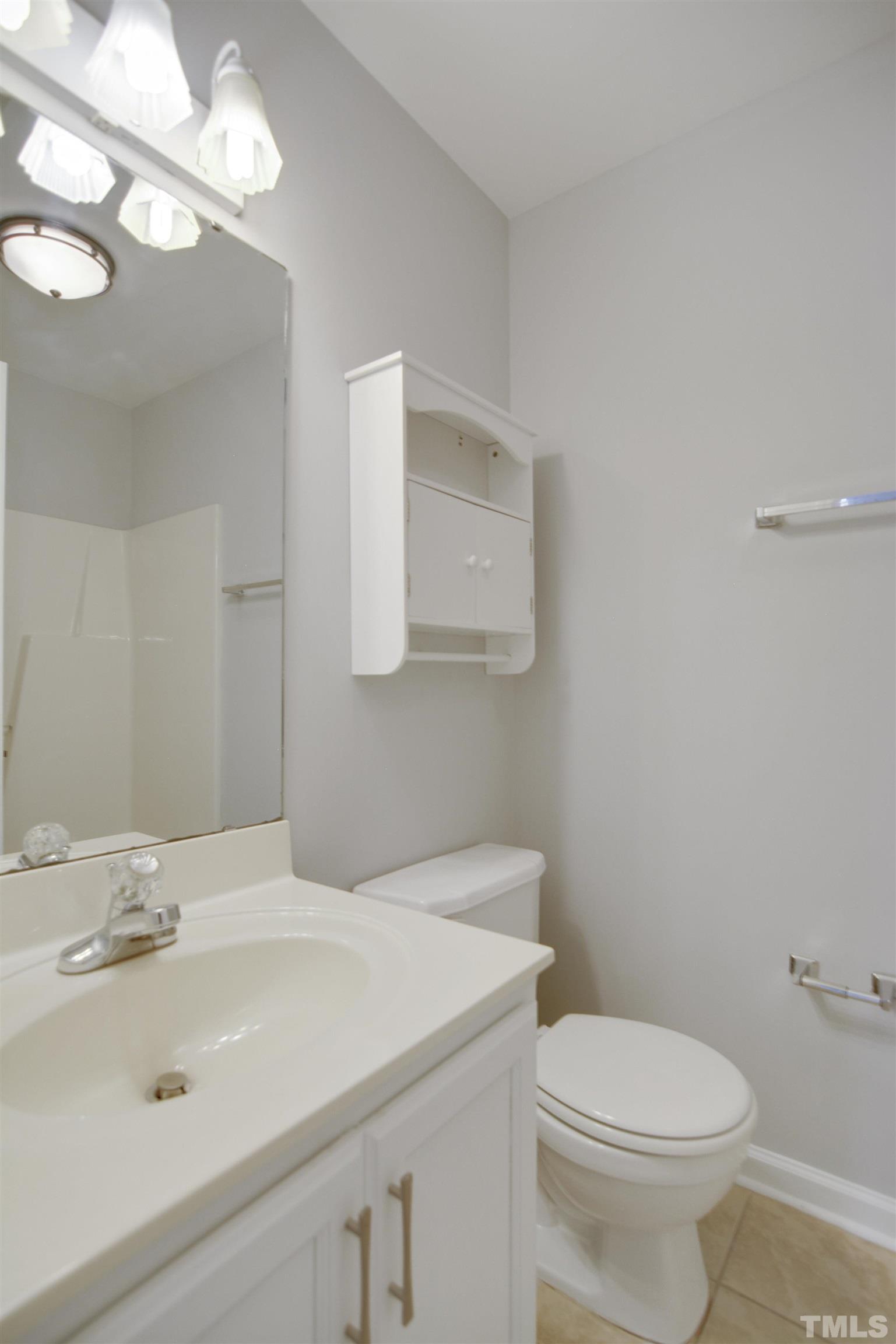 9221 Pennythorne Court Raleigh, NC 27615 - Photo 14 of 23 a bathroom with a sink a toilet and a mirror