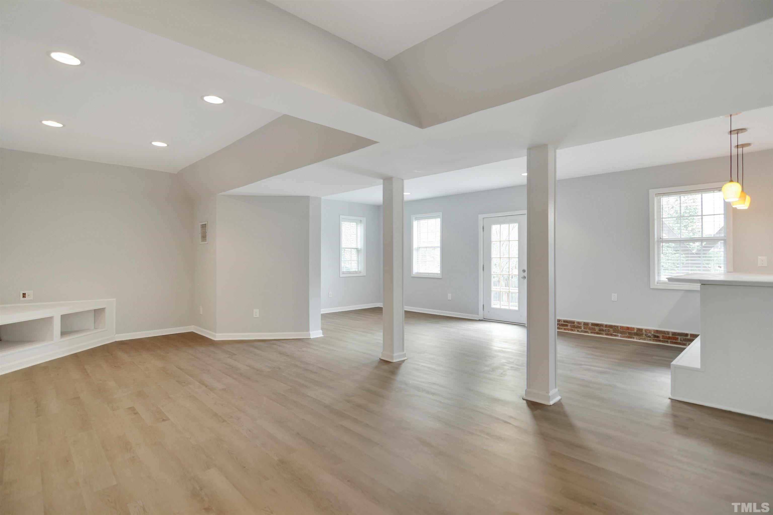9221 Pennythorne Court Raleigh, NC 27615 - Photo 15 of 23 an empty room with wooden floor and windows
