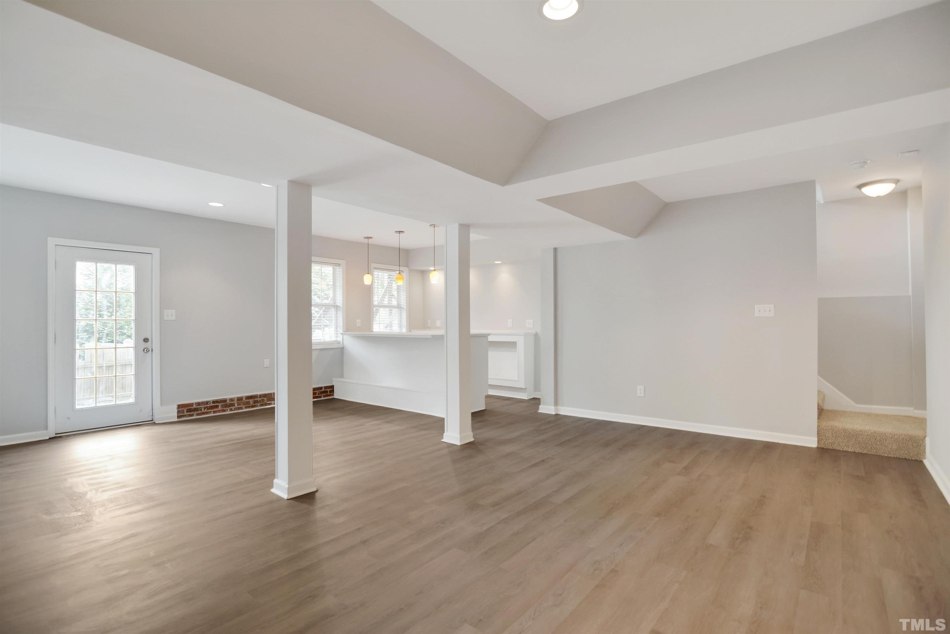 9221 Pennythorne Court Raleigh, NC 27615 - Photo 16 of 23 an empty room with wooden floor and windows
