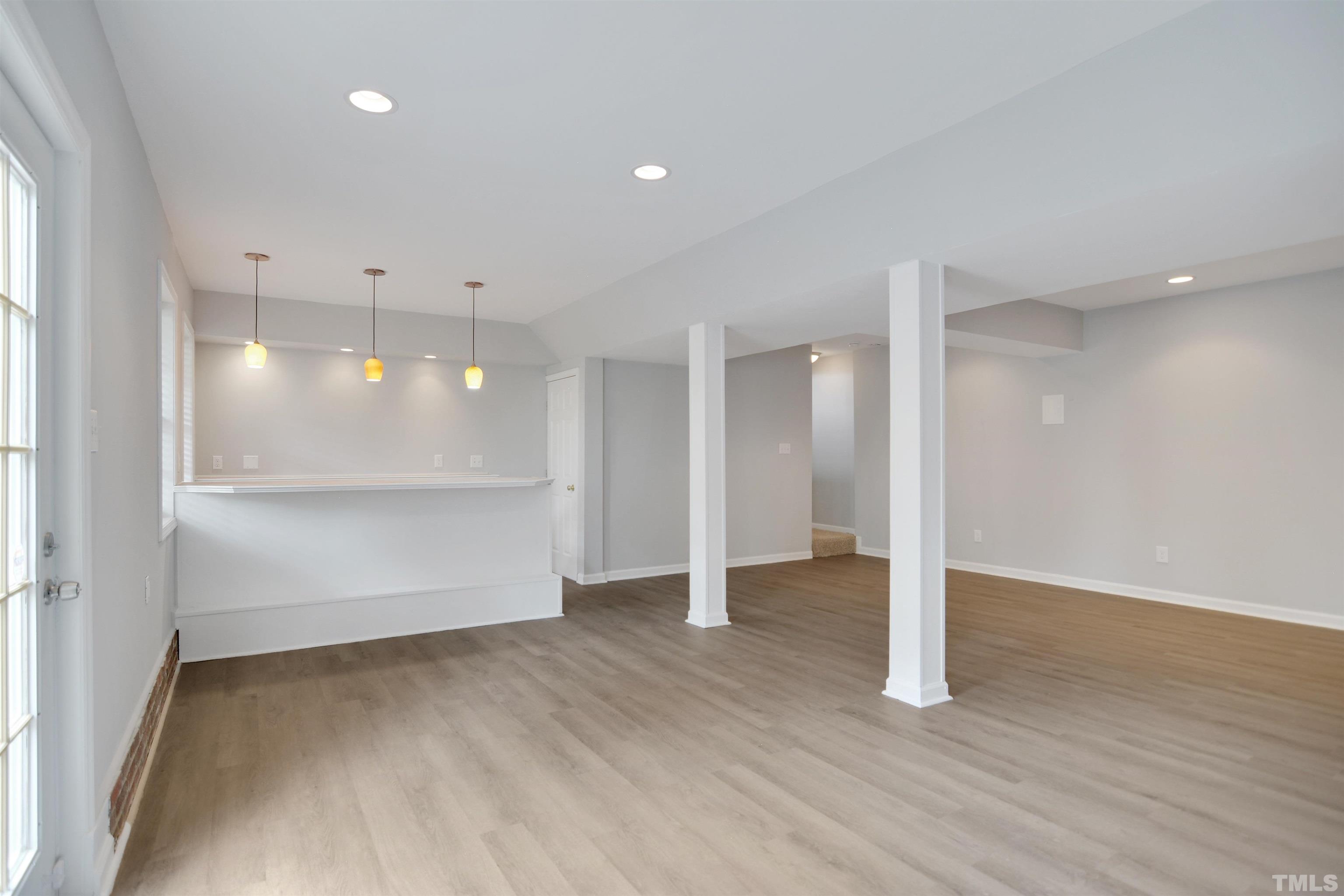 9221 Pennythorne Court Raleigh, NC 27615 - Photo 17 of 23 a view of an empty room with wooden floor