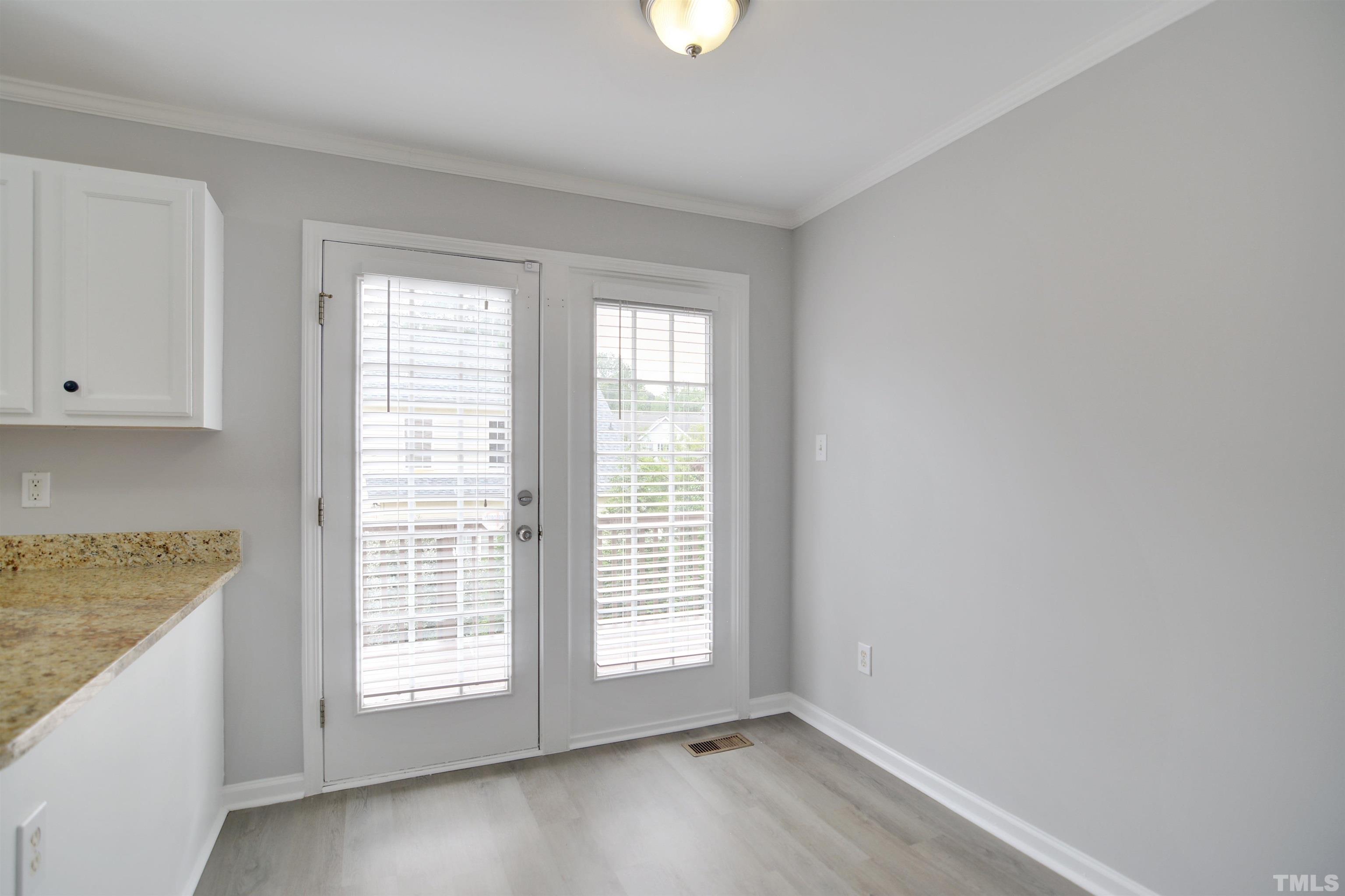 9221 Pennythorne Court Raleigh, NC 27615 - Photo 6 of 23 wooden floor in an empty room with a window