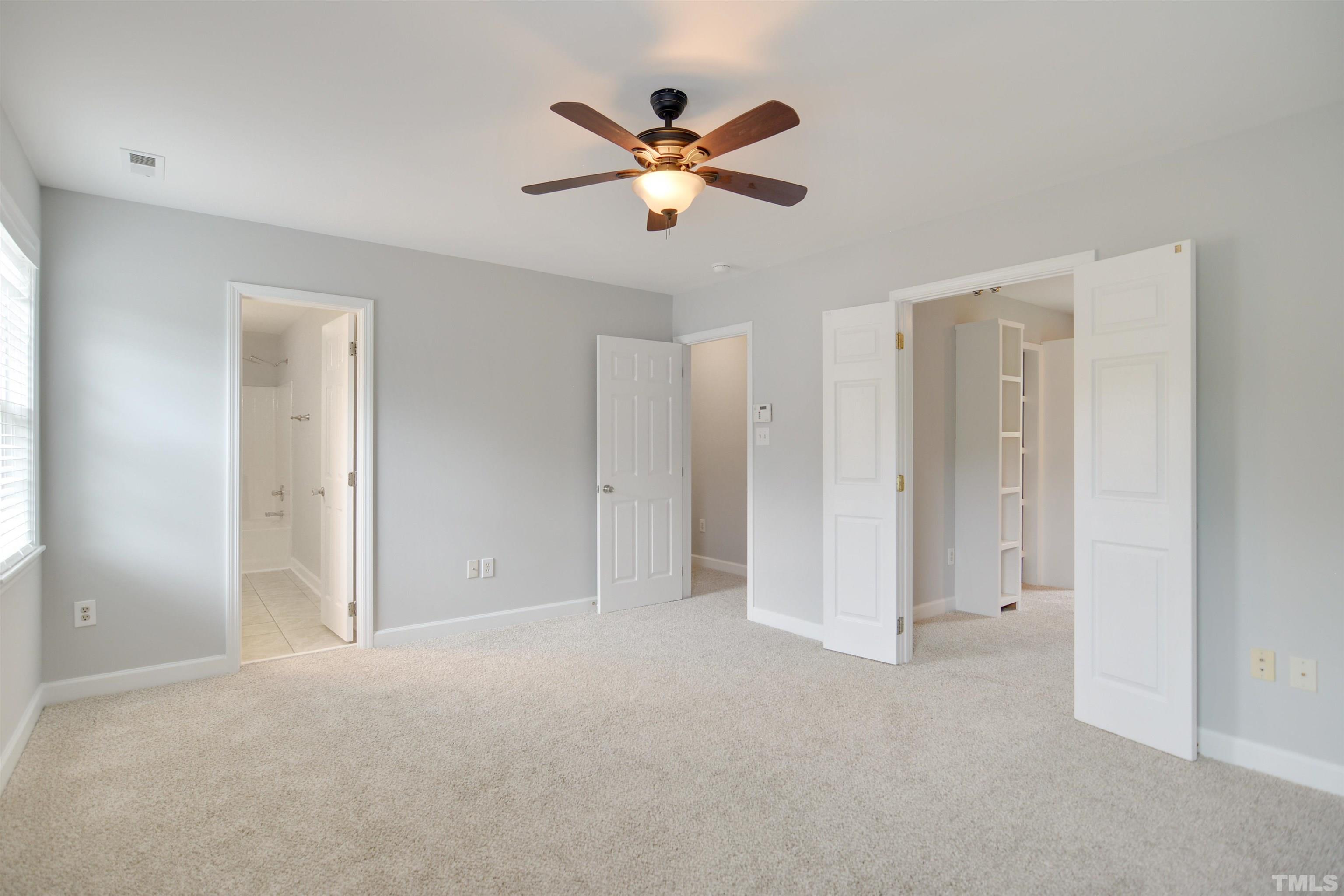 9221 Pennythorne Court Raleigh, NC 27615 - Photo 8 of 23 a view of an empty room with a ceiling fan