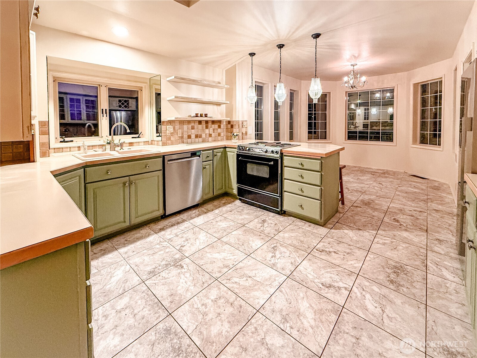 266 Quillayute Place La Conner, WA 98257 - Photo 5 of 17 a large kitchen with a stove a sink dishwasher and a oven with wooden cabinets