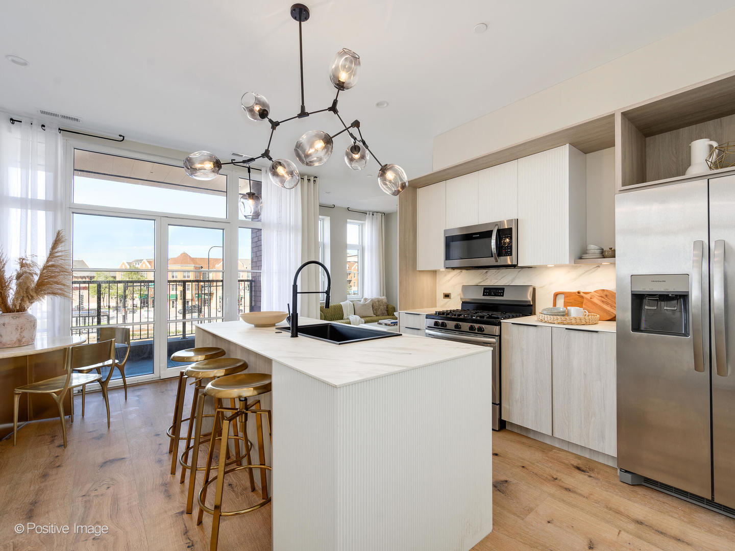 11 West Prospect Avenue, Unit 316 Mount Prospect, IL 60056 - Photo 3 of 72 a kitchen with stainless steel appliances granite countertop a stove a refrigerator a oven a sink a stove and a dining table with wooden floor