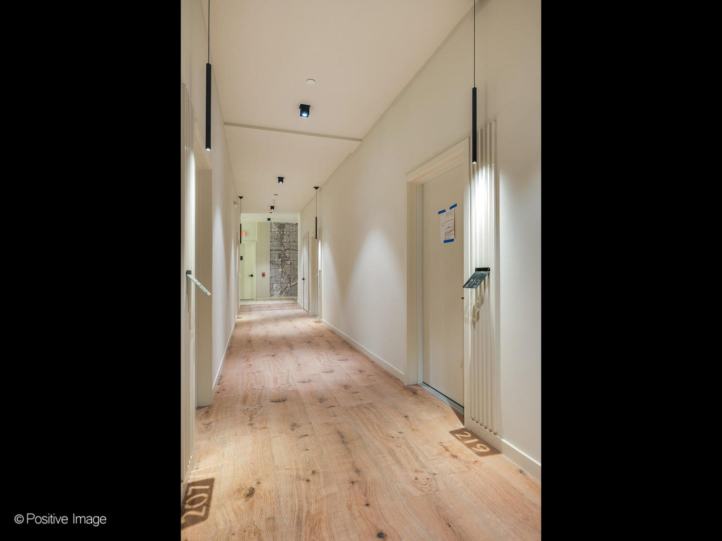 11 West Prospect Avenue, Unit 316 Mount Prospect, IL 60056 - Photo 44 of 72 a view of a hallway with wooden floor and a bathroom