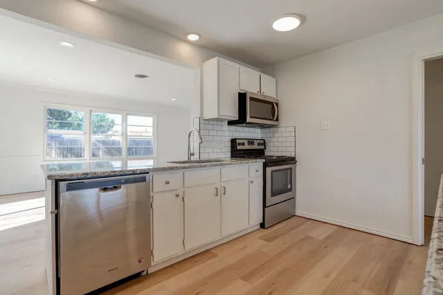 a view of a kitchen with granite countertop cabinets and window