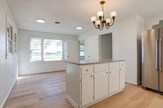 a view white cabinets with wooden floor