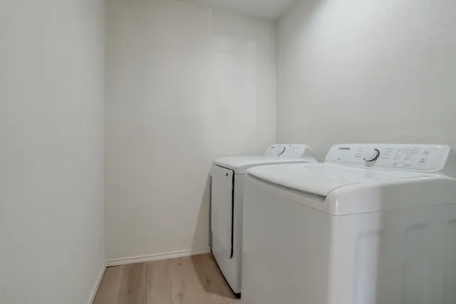 a bathroom with a granite countertop sink a mirror a bathtub and shower