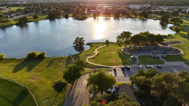 an aerial view of residential houses with outdoor space and lake view