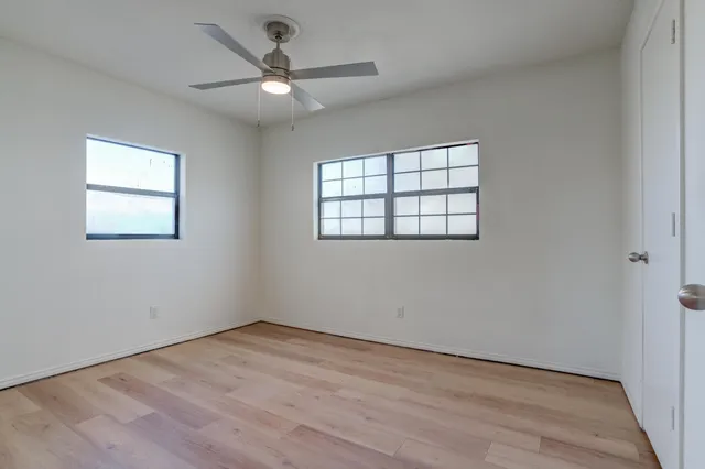 an empty room with a ceiling fan