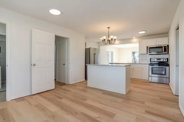 a view of a kitchen with granite countertop cabinets and stainless steel appliances