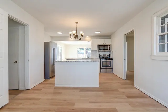 a view of a kitchen with an empty space and a window