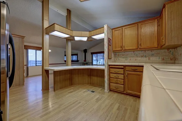 a kitchen with stainless steel appliances granite countertop a sink a stove and a wooden floors
