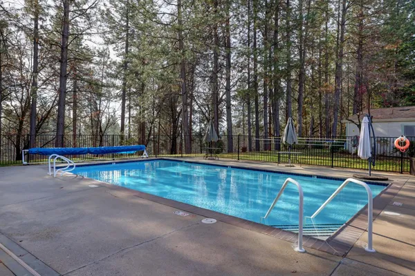 a swimming pool with outdoor seating and yard