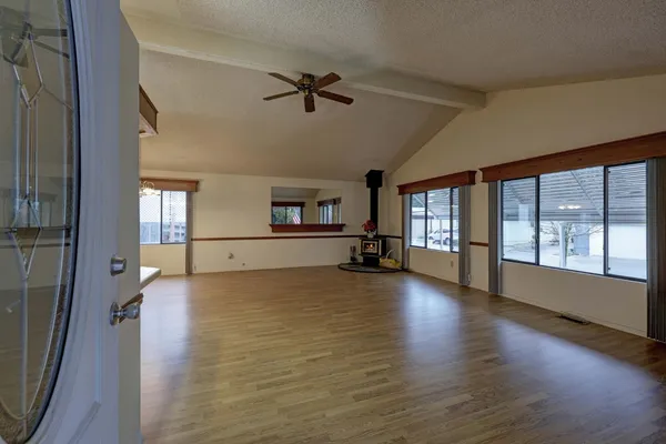 a big room with wooden floor and windows