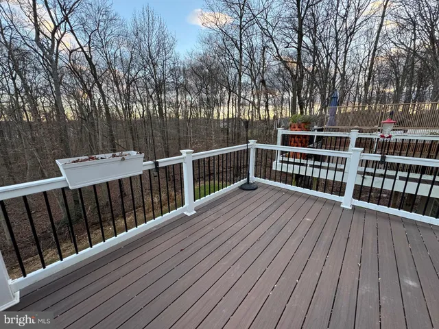 a balcony with wooden floor and fence