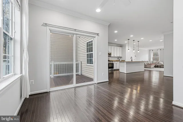 a view of a kitchen with wooden floor and a window