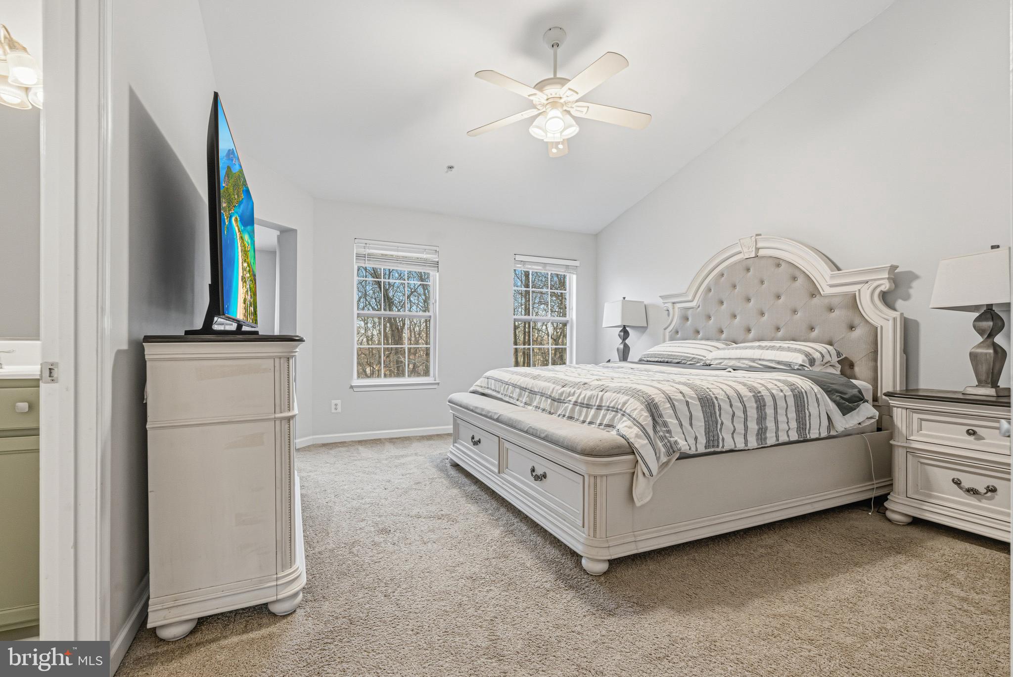 617 English Ivy Way Aberdeen, MD 21001 - Photo 15 of 35 a bedroom with a large bed a chandelier and a flat tv screen on dresser