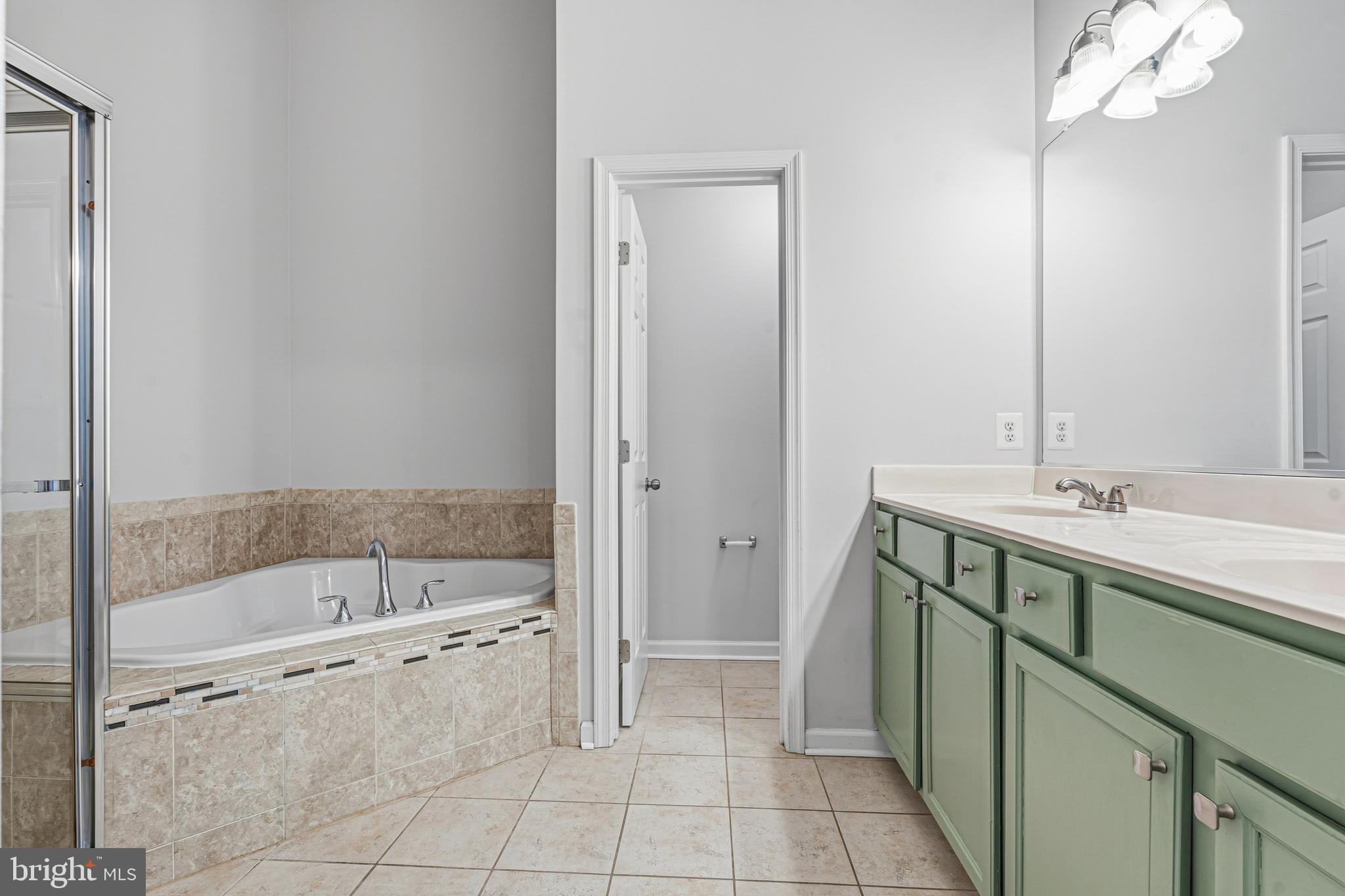 617 English Ivy Way Aberdeen, MD 21001 - Photo 17 of 35 a bathroom with a bathtub sink and mirror