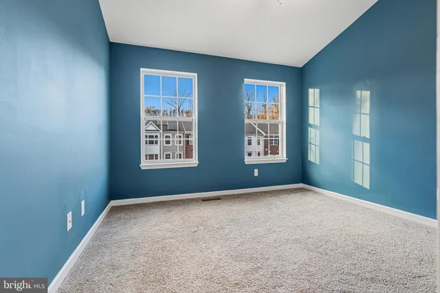 a view of an empty room with windows