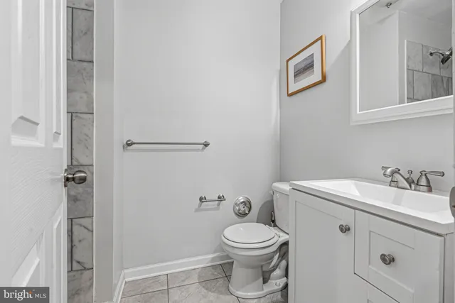 a bathroom with a toilet a sink and shower