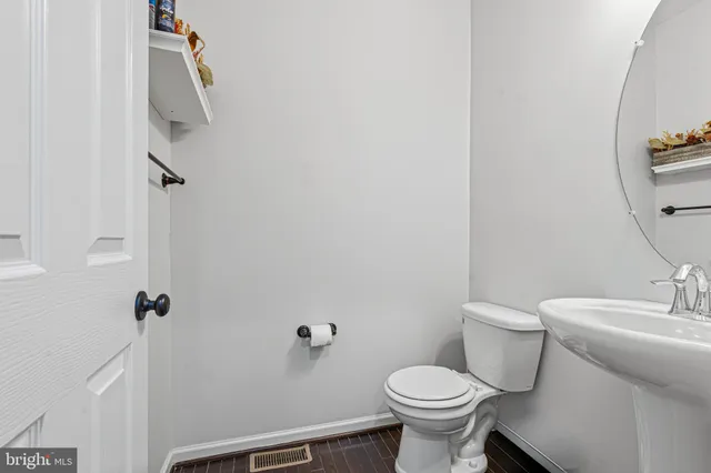 a white toilet sitting next to a bathroom sink
