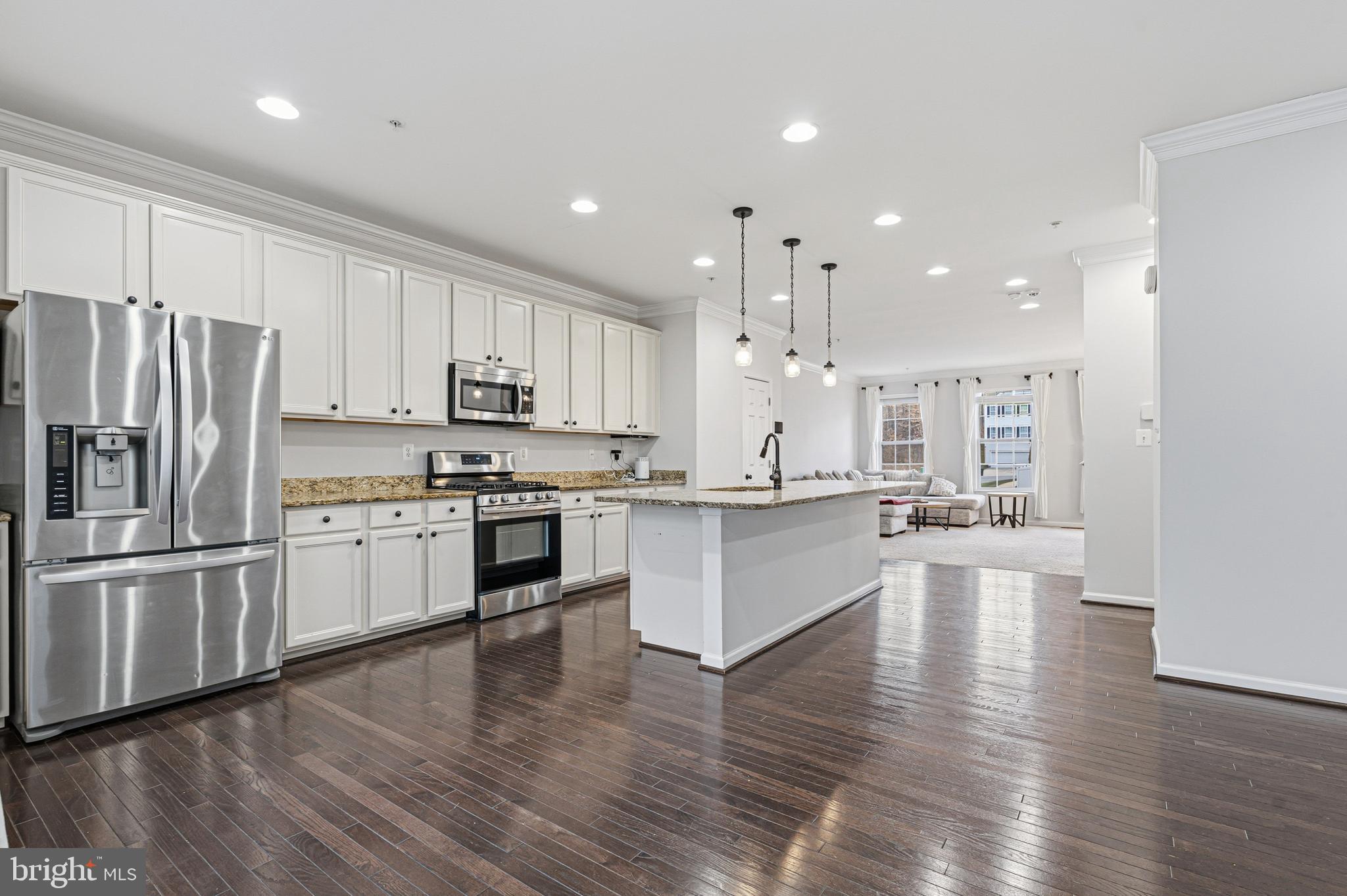 617 English Ivy Way Aberdeen, MD 21001 - Photo 9 of 35 a view of kitchen with center island wooden floor stainless steel appliances and cabinets