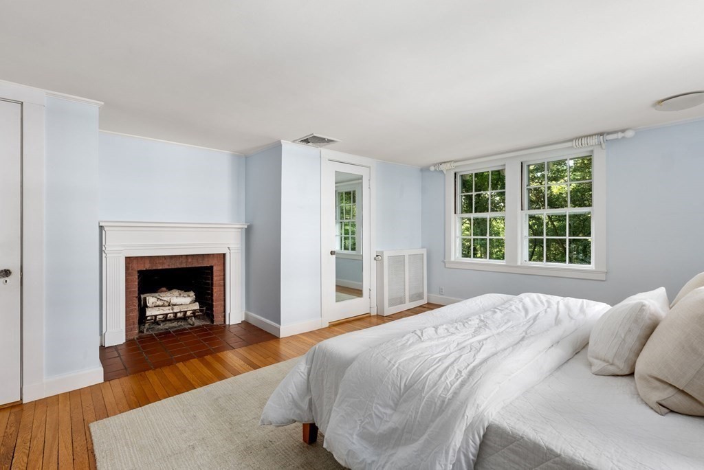 209 Meadowbrook Road Weston, MA 02493 - Photo 23 of 32 a bedroom with a bed and a fireplace