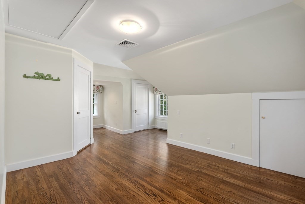 209 Meadowbrook Road Weston, MA 02493 - Photo 28 of 32 an empty room with wooden floor and windows