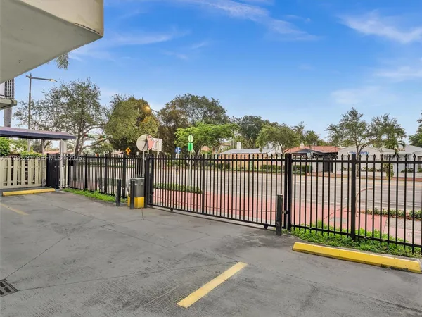 a view of a park with iron fence