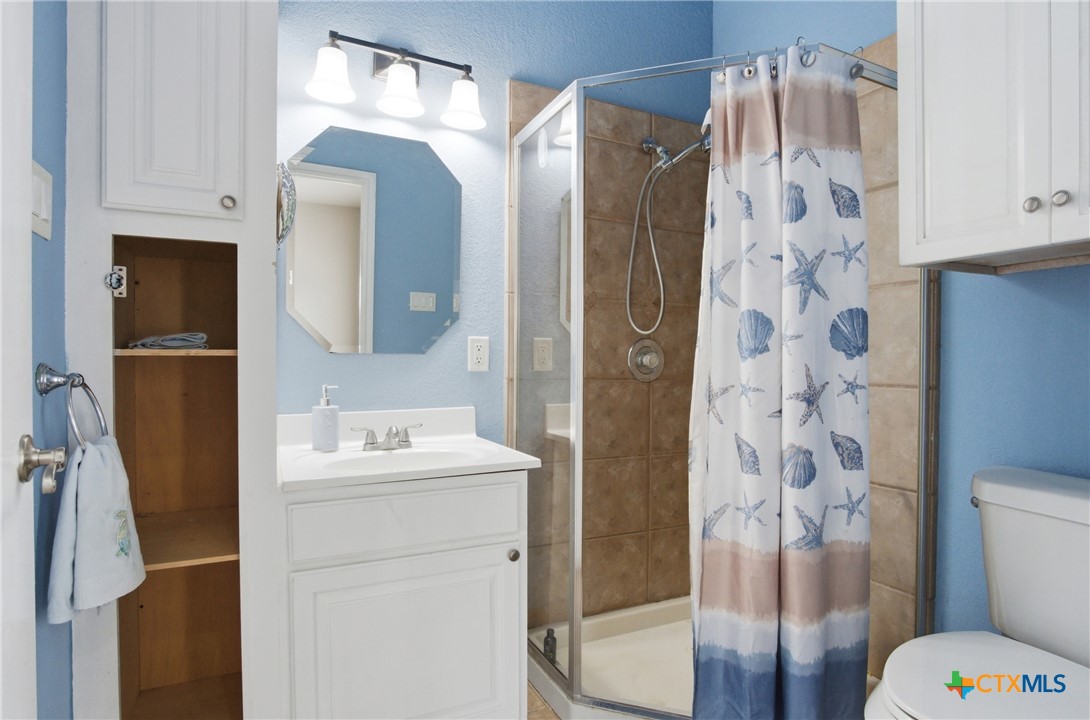 642 Phantom Rider Trail Spring Branch, TX 78070 - Photo 32 of 41 a bathroom with a sink toilet and shower