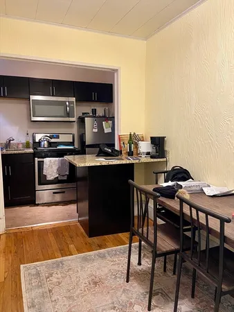a kitchen with a table and chairs in it