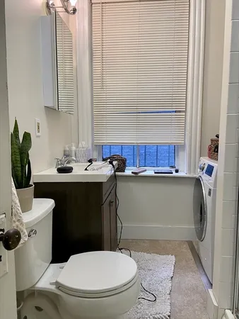 a bathroom with a sink a toilet and mirror