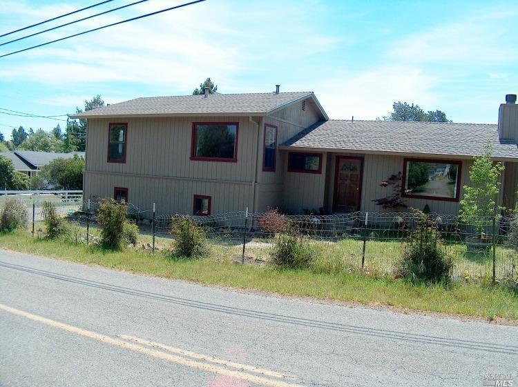 a front view of a house with a yard table and chairs