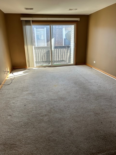 10620 Brooks Lane, Unit 2C2 Chicago Ridge, IL 60415 - Photo 4 of 12 a view of an empty room with a window
